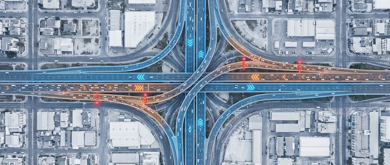 Highway interchange with traffic signals and metering lights managing flow, showing smooth lanes and redirected overflow traffic under heavy load